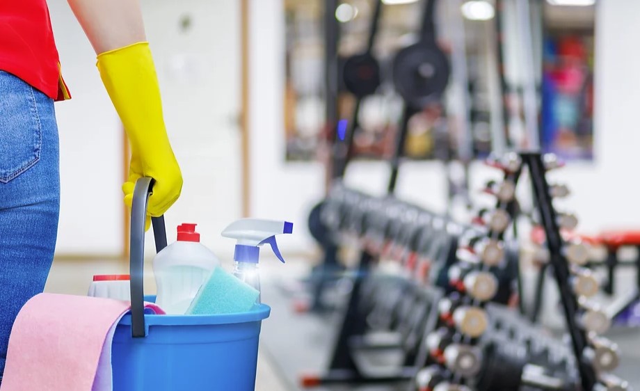 cleaning woman in gym stock image