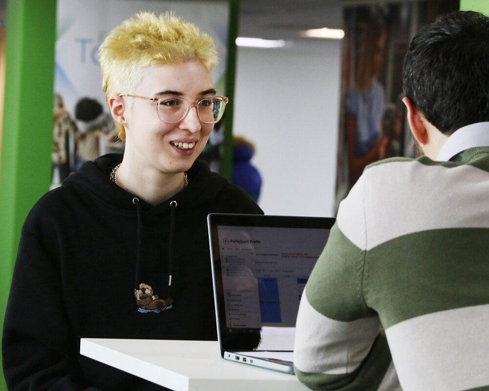 woman smiling, talking to her adviser